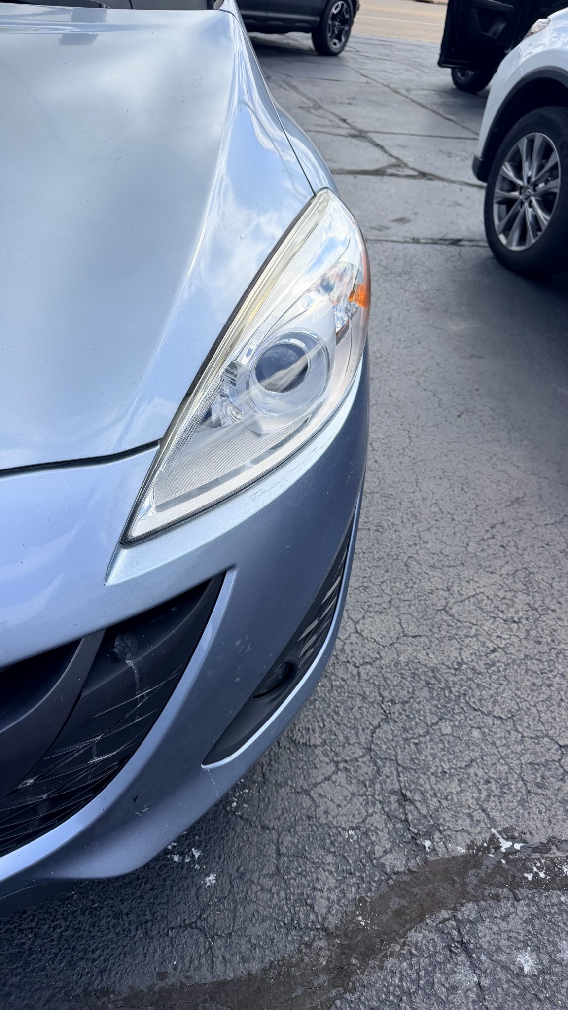 After headlight restoration showing clear restored lens on a silver vehicle